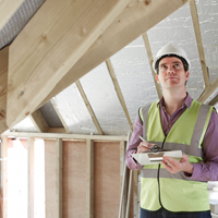 Energy efficiency expert conducting a home energy audit to identify areas for energy savings